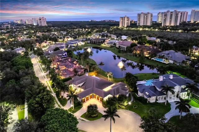 aerial view at dusk with a water view