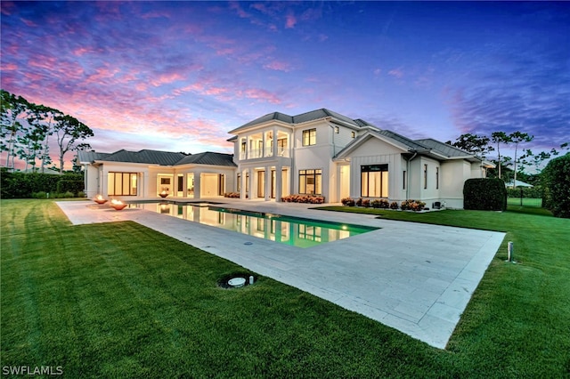 171 N St, Naples, FL 34108 - rear view of house with a patio area, an outdoor pool, a yard, and stucco siding