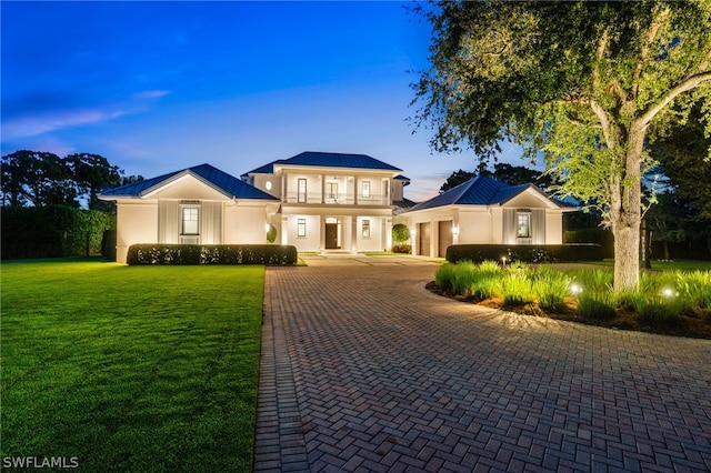 171 N St, Naples, FL 34108 - view of front facade featuring a garage, a balcony, decorative driveway, a lawn, and stucco siding