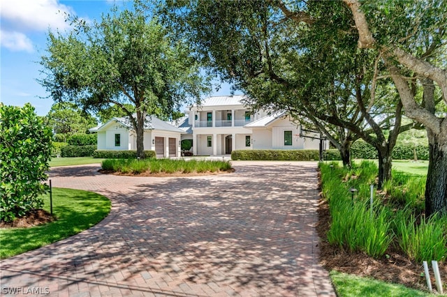 171 N St, Naples, FL 34108 - view of front of property with a balcony, decorative driveway, and stucco siding