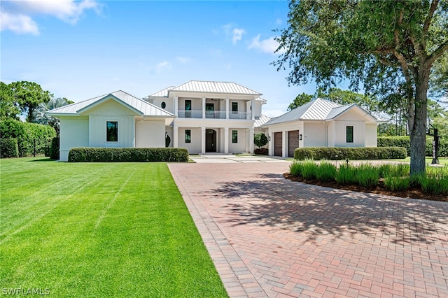 171 N St, Naples, FL 34108 - modern farmhouse featuring a standing seam roof, decorative driveway, a garage, and a balcony