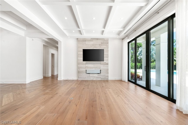 unfurnished living room featuring beamed ceiling, light wood-type flooring, and coffered ceiling