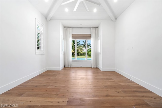 spare room with ceiling fan, hardwood / wood-style floors, and lofted ceiling with beams