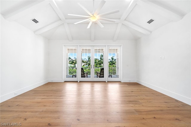 unfurnished living room with lofted ceiling with beams, light hardwood / wood-style flooring, and french doors