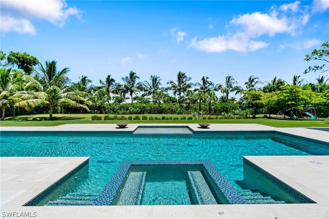 view of swimming pool with an in ground hot tub