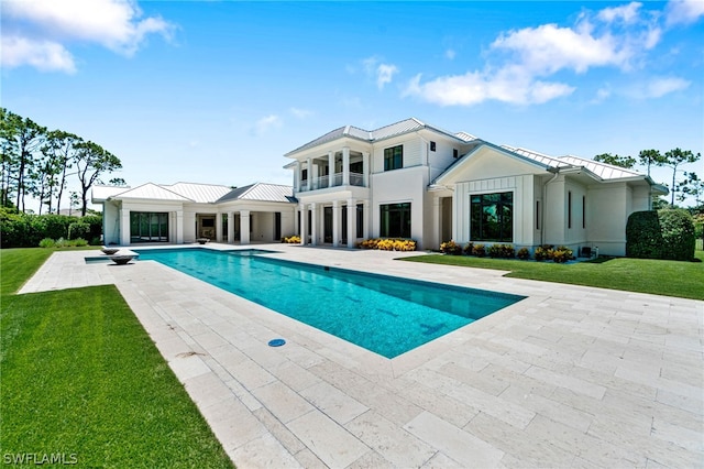 view of swimming pool with a patio area and a yard