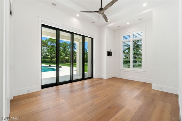 spare room with ceiling fan and light wood-type flooring