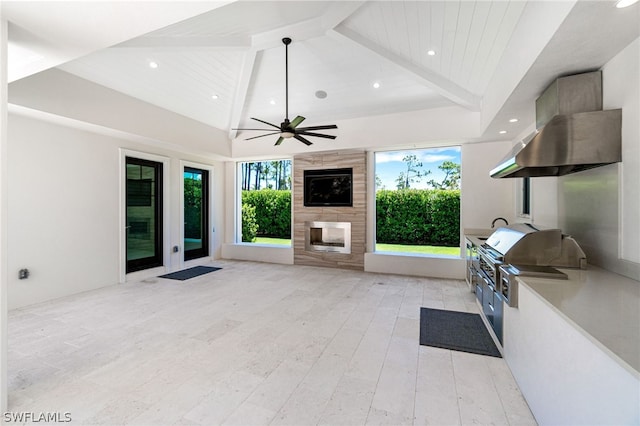 view of patio with a fireplace, area for grilling, ceiling fan, and a grill