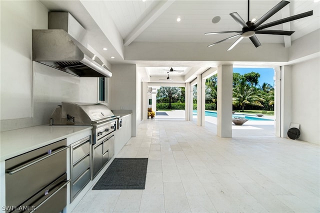 view of patio with area for grilling, a grill, and ceiling fan