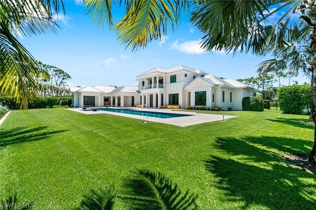171 N St, Naples, FL 34108 - back of property featuring an outdoor pool, a yard, stucco siding, and a patio
