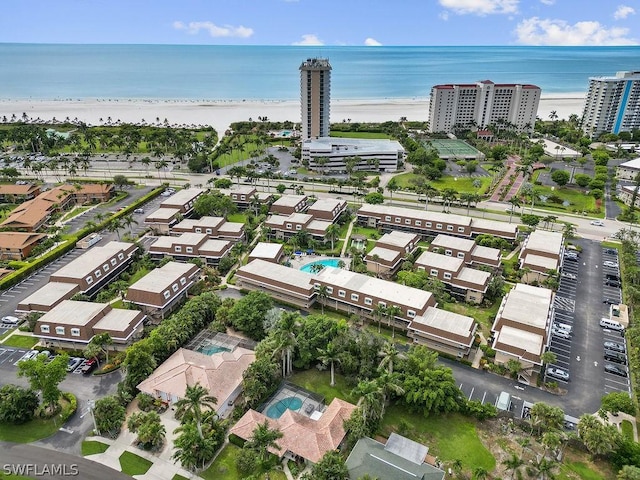 drone / aerial view with a water view and a beach view