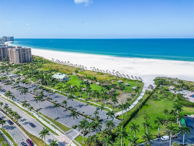 birds eye view of property featuring a water view and a beach view