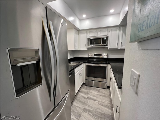 kitchen with white cabinetry and stainless steel appliances