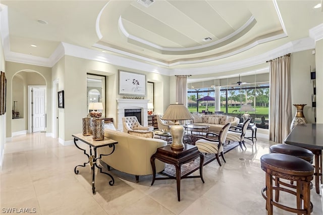 living room with crown molding and a raised ceiling