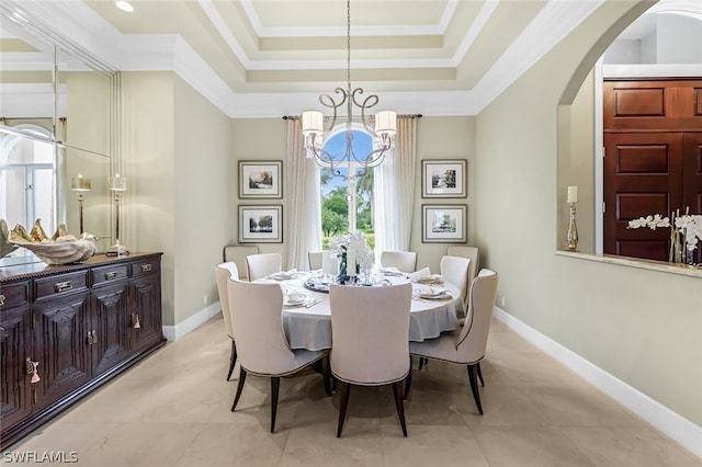 dining area featuring ornamental molding, light tile patterned floors, a notable chandelier, and a tray ceiling