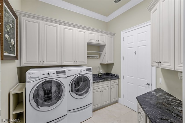 clothes washing area featuring sink, crown molding, cabinets, light tile patterned floors, and independent washer and dryer