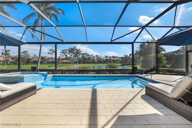 view of swimming pool with glass enclosure, a patio area, a water view, and an in ground hot tub