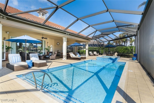 view of pool featuring an in ground hot tub, a patio area, ceiling fan, and a lanai