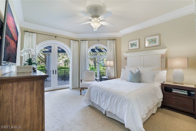 bedroom with crown molding, light colored carpet, access to exterior, and french doors