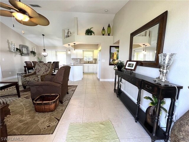 tiled living room featuring lofted ceiling and ceiling fan