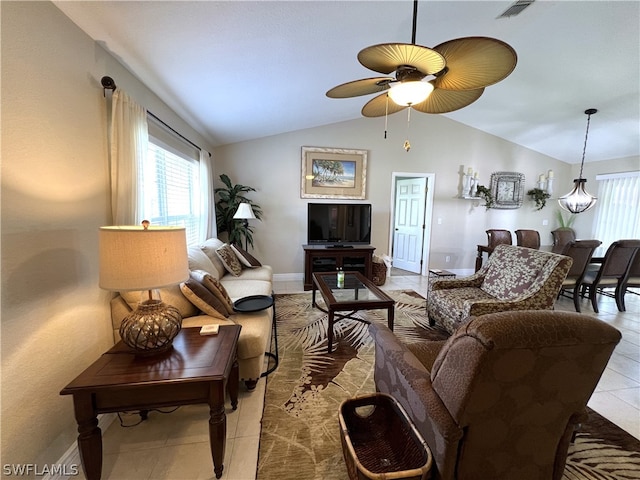 tiled living room featuring ceiling fan and lofted ceiling