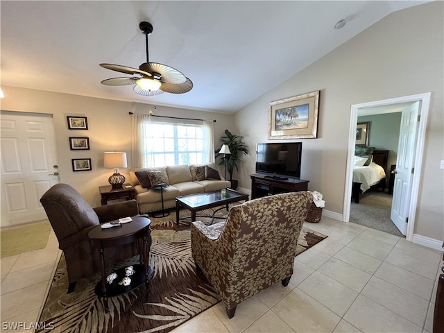 living room featuring ceiling fan, light tile flooring, and lofted ceiling