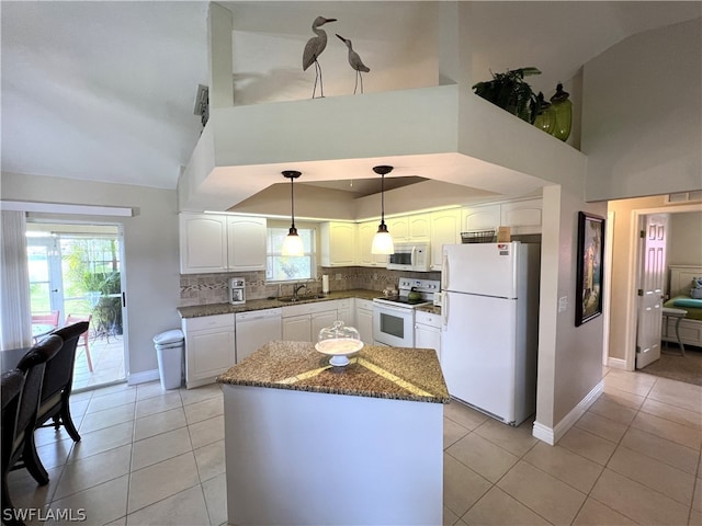 kitchen featuring hanging light fixtures, white appliances, white cabinetry, and backsplash