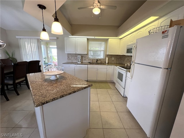 kitchen featuring white appliances, white cabinets, backsplash, pendant lighting, and light tile flooring