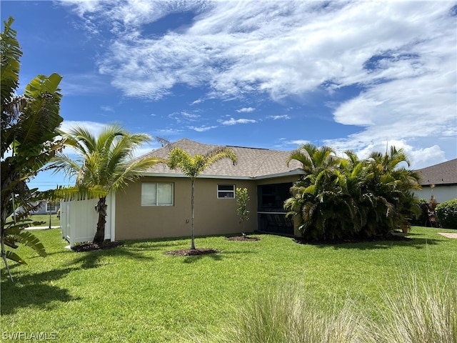 rear view of house with a yard