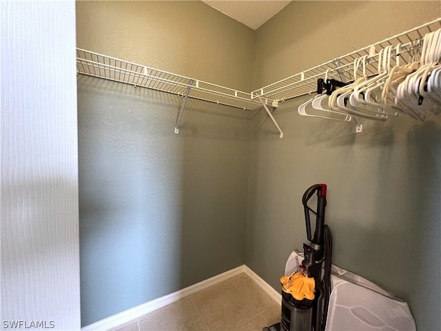 walk in closet featuring tile flooring