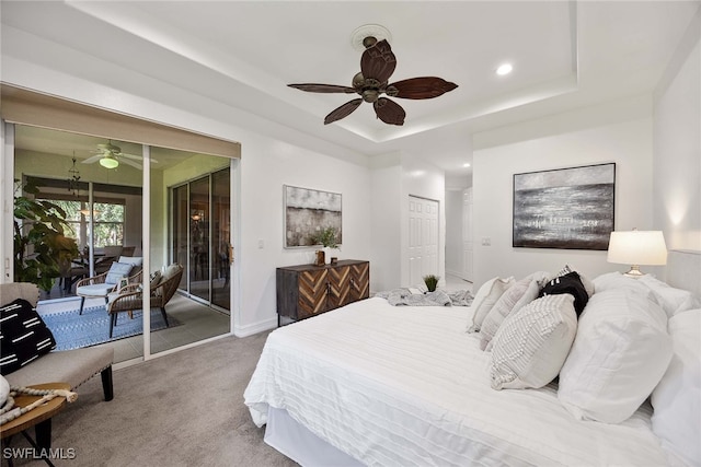 bedroom with a closet, access to outside, ceiling fan, carpet floors, and a raised ceiling