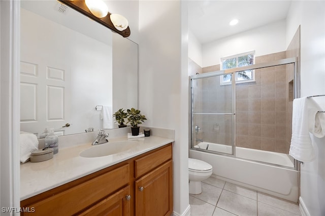 full bathroom featuring combined bath / shower with glass door, vanity, toilet, and tile patterned floors