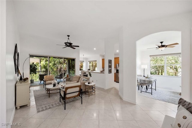 tiled dining space with a healthy amount of sunlight and ceiling fan