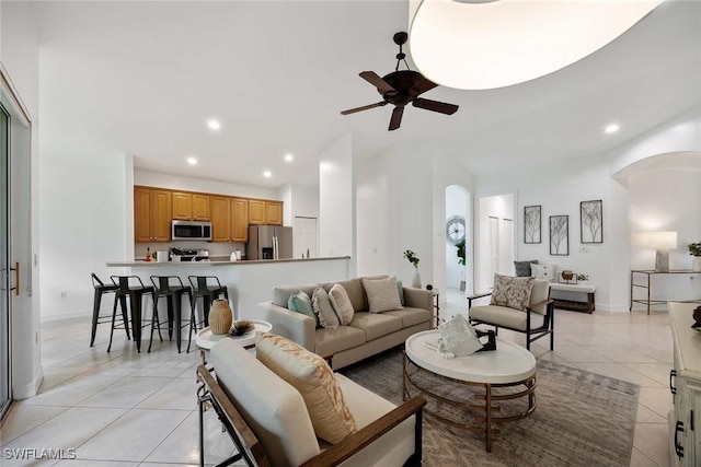 tiled living room featuring ceiling fan