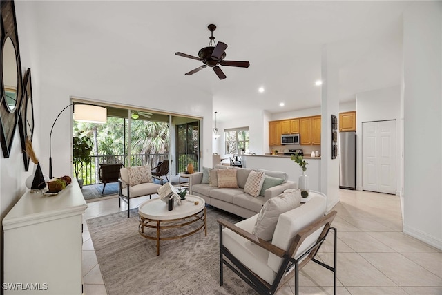 tiled living room with a towering ceiling and ceiling fan