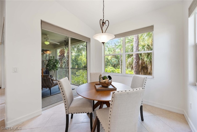 tiled dining space with vaulted ceiling