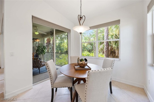 1732 Tarpon Bay Dr S Unit 203, Naples, FL 34119 - dining area with light tile patterned flooring, baseboards, and ceiling fan