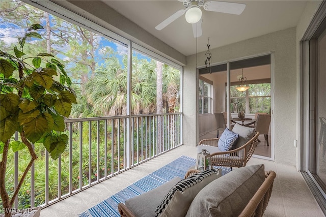 sunroom featuring ceiling fan