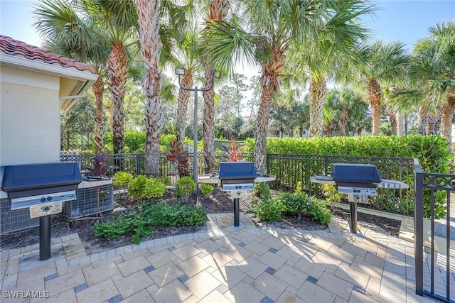 1732 Tarpon Bay Dr S Unit 203, Naples, FL 34119 - view of patio / terrace featuring fence and grilling area