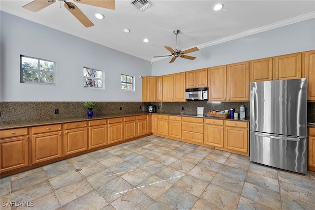 kitchen with dark stone countertops, tasteful backsplash, ceiling fan, appliances with stainless steel finishes, and crown molding