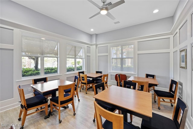 dining room with light hardwood / wood-style flooring and ceiling fan