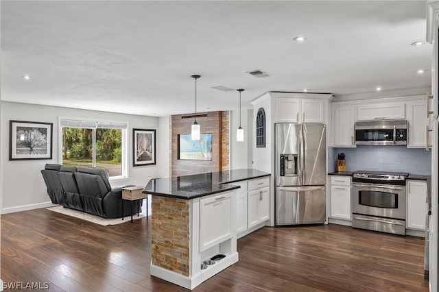 kitchen featuring white cabinetry, decorative backsplash, dark hardwood / wood-style floors, and stainless steel appliances