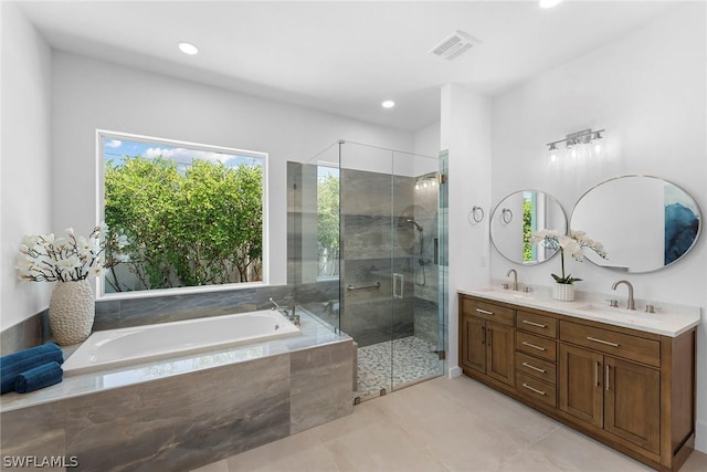 bathroom with shower with separate bathtub, vanity, and tile patterned floors