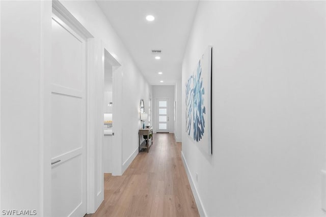 hall with light hardwood / wood-style floors