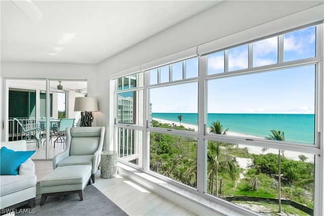 sunroom / solarium with a water view and a wealth of natural light