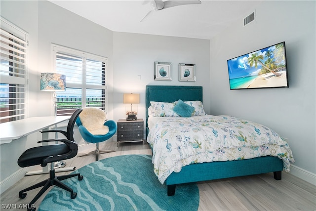 bedroom with hardwood / wood-style flooring and ceiling fan