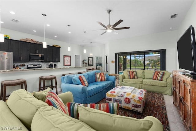 tiled living room with ceiling fan