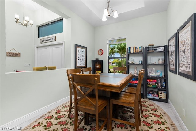 dining space featuring light tile patterned floors and a notable chandelier