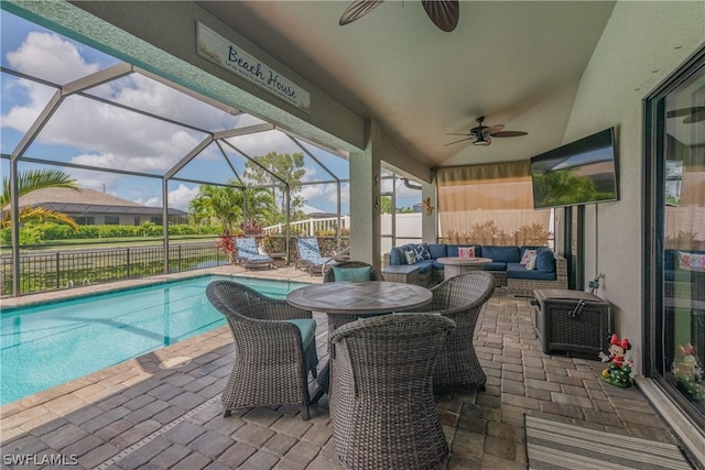 view of swimming pool featuring a lanai, an outdoor living space, ceiling fan, and a patio