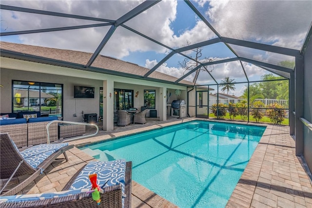 view of swimming pool with an outdoor living space, glass enclosure, grilling area, and a patio area